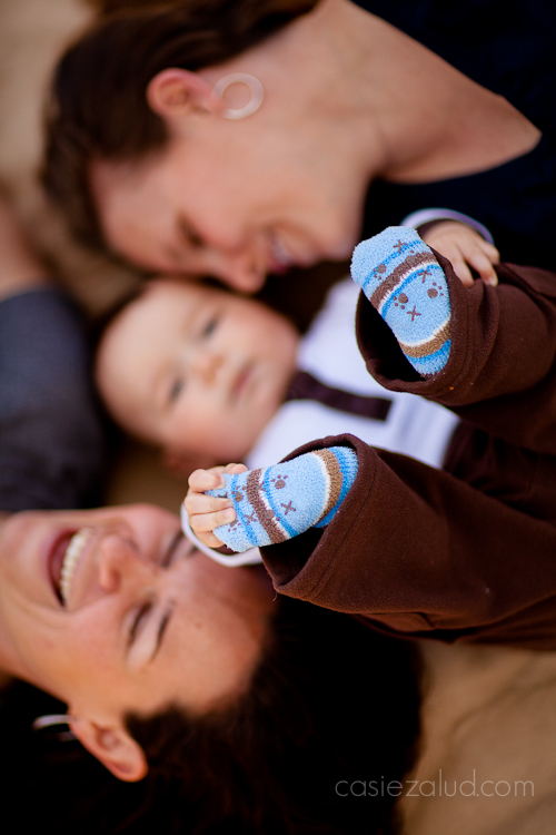 child laying on back with moms, feet in focus