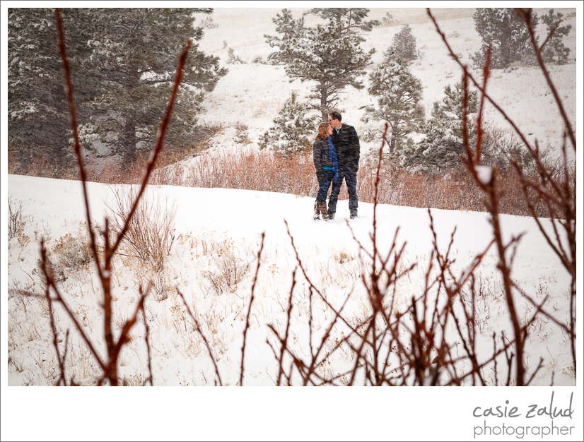 engaged couple kissing in a blizzard in Boulder