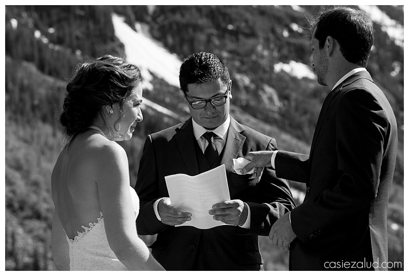 groom tucking the officiant's pocket square into his pocket after wiping a tear from his bride's eyes during a Maroon Bells Wedding