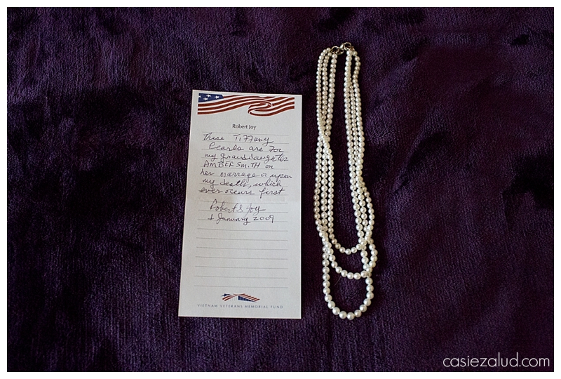 a set of pearls beside a note from the bride's grandfather stating if he should die the pearls are for his granddaughter on her wedding day
