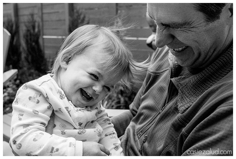Close up of a toddler and dad's faces as they laugh their heads off