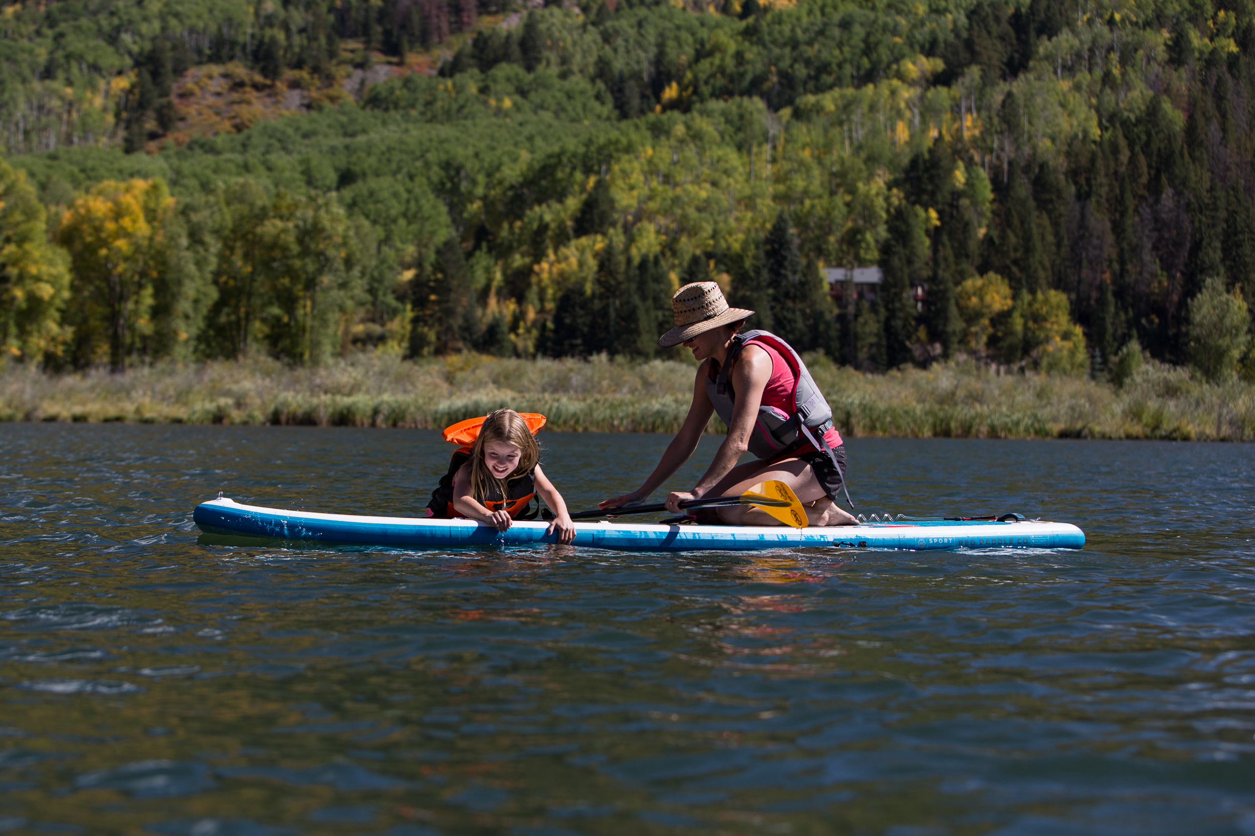 mom and daughter on paddleboard at marble colorado during a vacation photo session